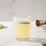 A glass of a Frozen Mule sits on a marble counter